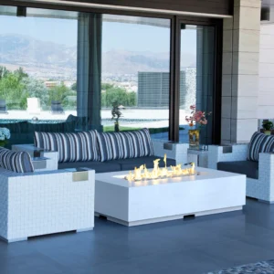 White woven rectangular fire table with striped cushioned seating overlooking mountain view